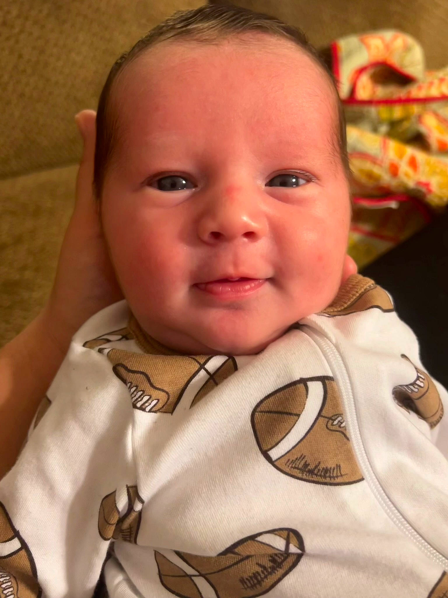 Ezra is registered to the contest to win money with this photo: baby, baby_toddler_clothing, cheek, chin, ear, eye, eyelash, face, facial_expression, gesture, happy, head, iris, lip, mouth, nose, person, skin, sleeve, smile