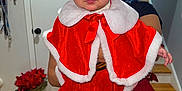 Haisley joined the competition — help win amazing prizes! baby, child, christmas, curtains, cute, door, festive_clothing, heart_shaped, holiday, home, indoor, person_holding, plant, portrait, red_cape, santa_hat, smiling, stairs, sunglasses, wooden_floor