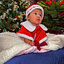 Haisley joined the competition — help win amazing prizes! baby, child, christmas, holiday, festive_clothing, santa_hat, blanket, indoor, decorations, christmas_tree, poinsettia, cute, portrait, holiday_season, red_clothing, white_trim, cozy, smiling, infant, celebration