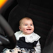 Victoria participe au concours pour gagner de l'argent avec cette photo : baby, smiling, child, car_seat, black_seat, white_collar, floral_skirt, cute, portrait, happy, infant, clothing, seat, seatbelt, indoors, person, face, head, sitting, cute_outfit