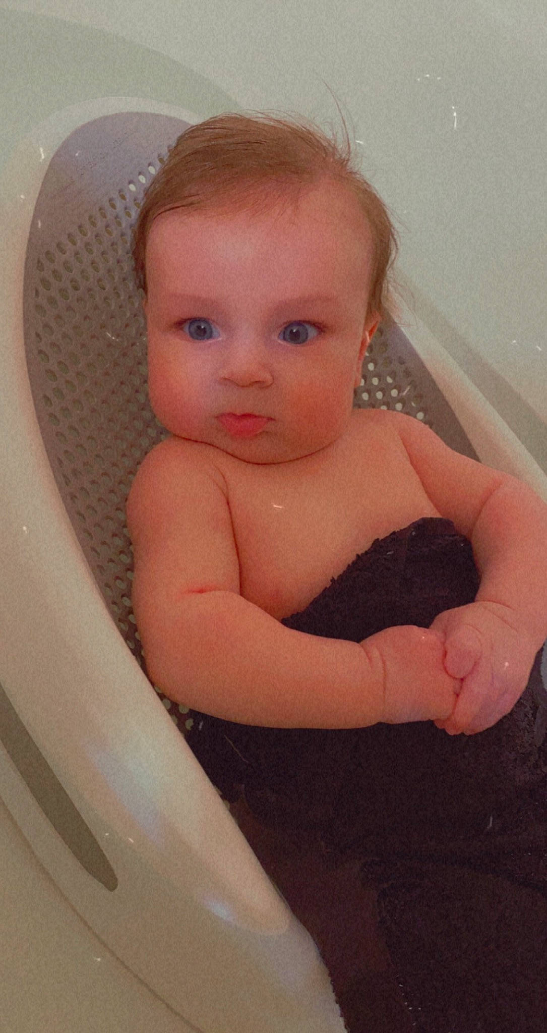 Corbin is registered to the contest to win money with this photo: arm, baby, bathing, cheek, eye, eyelash, finger, hair, hand, head, human_body, iris, lip, mouth, nose, organ, person, plumbing_fixture, skin, stomach