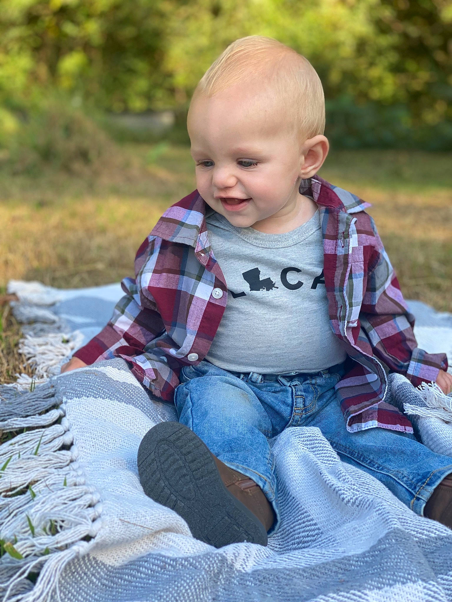 Eli joined the competition — help win amazing prizes! baby, baby_toddler_clothing, child, eye, facial_expression, fun, grass, happy, jeans, leisure, pattern, people_in_nature, person, plaid, plant, skin, smile, toddler, tree, vertebrate