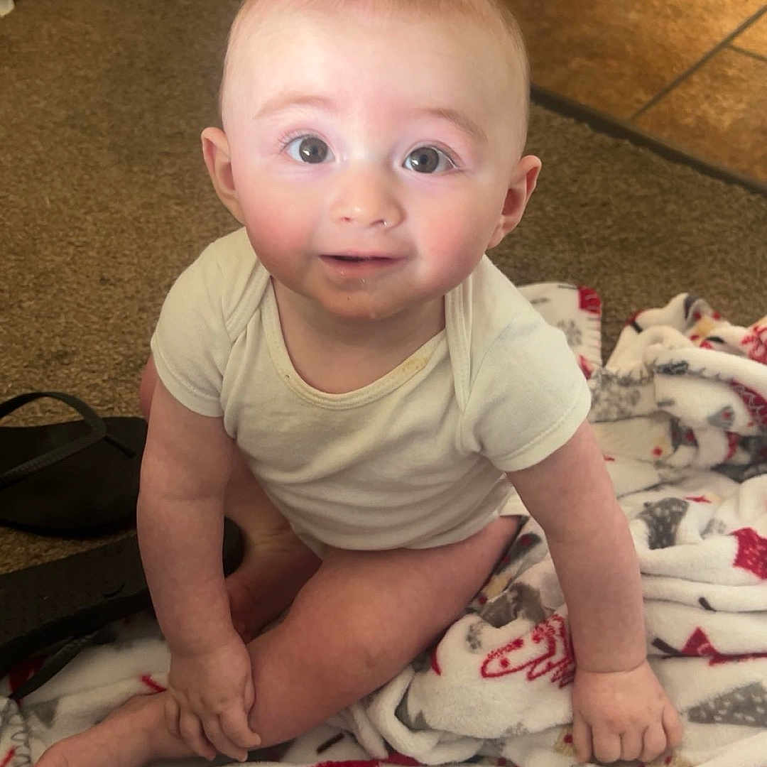 Reid is registered to the contest to win money with this photo: baby, babycrawling, blanket, clothing, crawling, crib, diaper, face, furniture, head, infantbed, newborn, pants, person, photography, portrait, quilt, sitting, standing, t_shirt