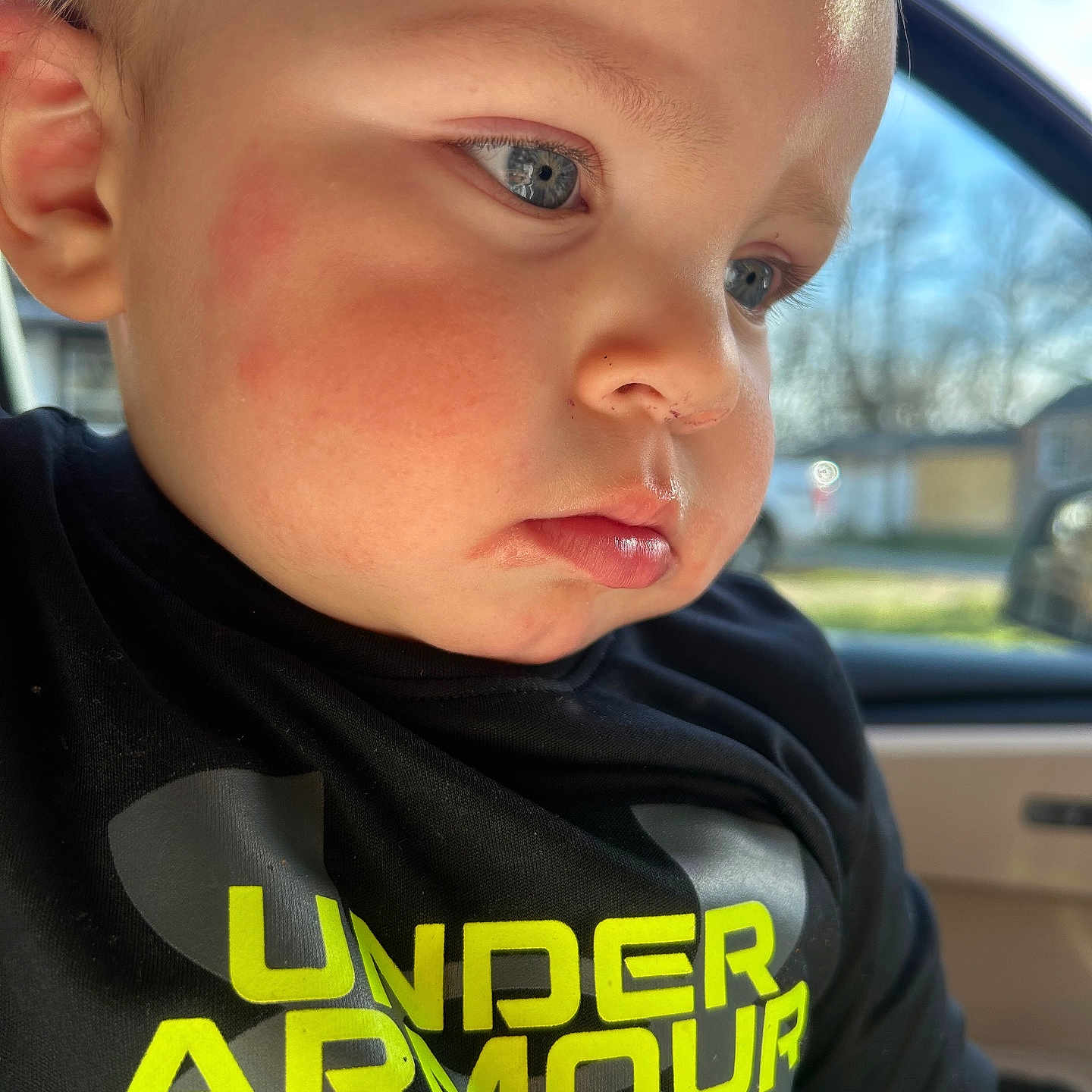 Payton joined the competition — help win amazing prizes! baby, black_shirt, blue_eyes, car_interior, casual_clothing, child, closeup, daylight, expression, face, indoors, portrait, serious, side_profile, skin, sunlight, toddler, under_armour, window, young_child