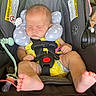 baby, infant, car_seat, sleeping, neck_pillow, pacifier, yellow_clothing, straps, safety, child, cute, toes, resting, indoors, seat, head_support, comfort, peaceful, adorable, nap