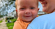 Ahvi Princess is registered to the contest to win money with this photo: baby, child, person, smile, glasses, blue_shirt, orange_shirt, outdoor, tree, sidewalk, grass, holding, happy, face, portrait, nature, daylight, skin, head, toddler