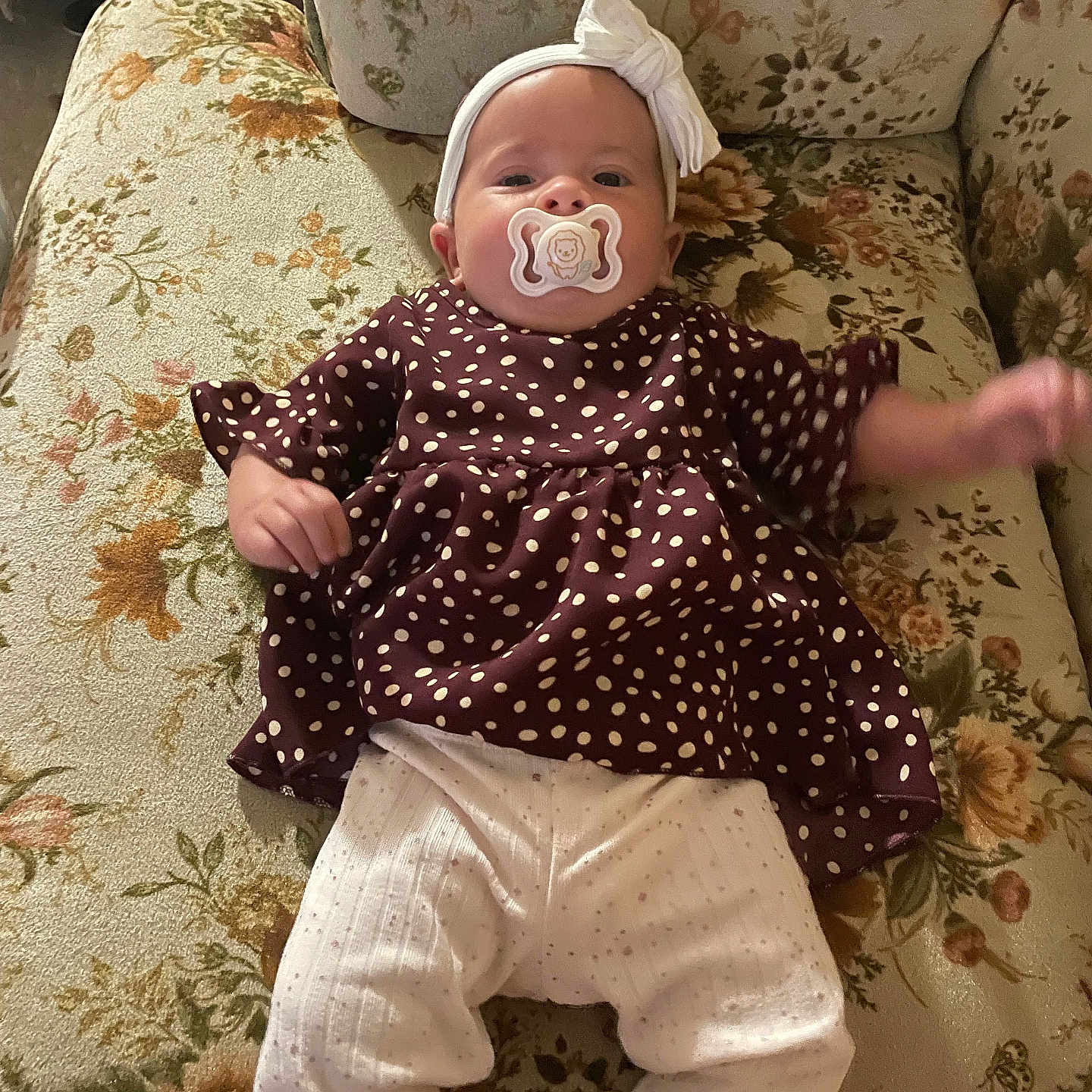 Ahvi Princess joined the competition — help win amazing prizes! baby, pacifier, headband, polka_dot, maroon_top, white_pants, couch, floral_pattern, vintage, infant, lying_down, cute, clothing, indoor, child, furniture, portrait, one_arm_raised, soft_lighting, relaxed