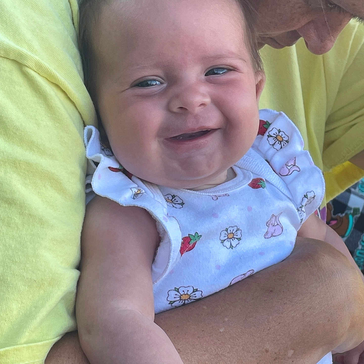 Ahvi Jane Bills joined the competition — help win amazing prizes! baby, smiling, adult, holding, white_outfit, flowers, strawberries, yellow_shirt, close_up, happy, child, person, skin, face, arm, affection, love, cute, portrait, outdoor