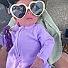 baby, blanket, casual, child, cute, fabric, hand, heart_shaped_glasses, holding, infant, lavender_clothing, outdoor, person, portrait, purple, reflection, relaxed, sunglasses, sunny, tattoo