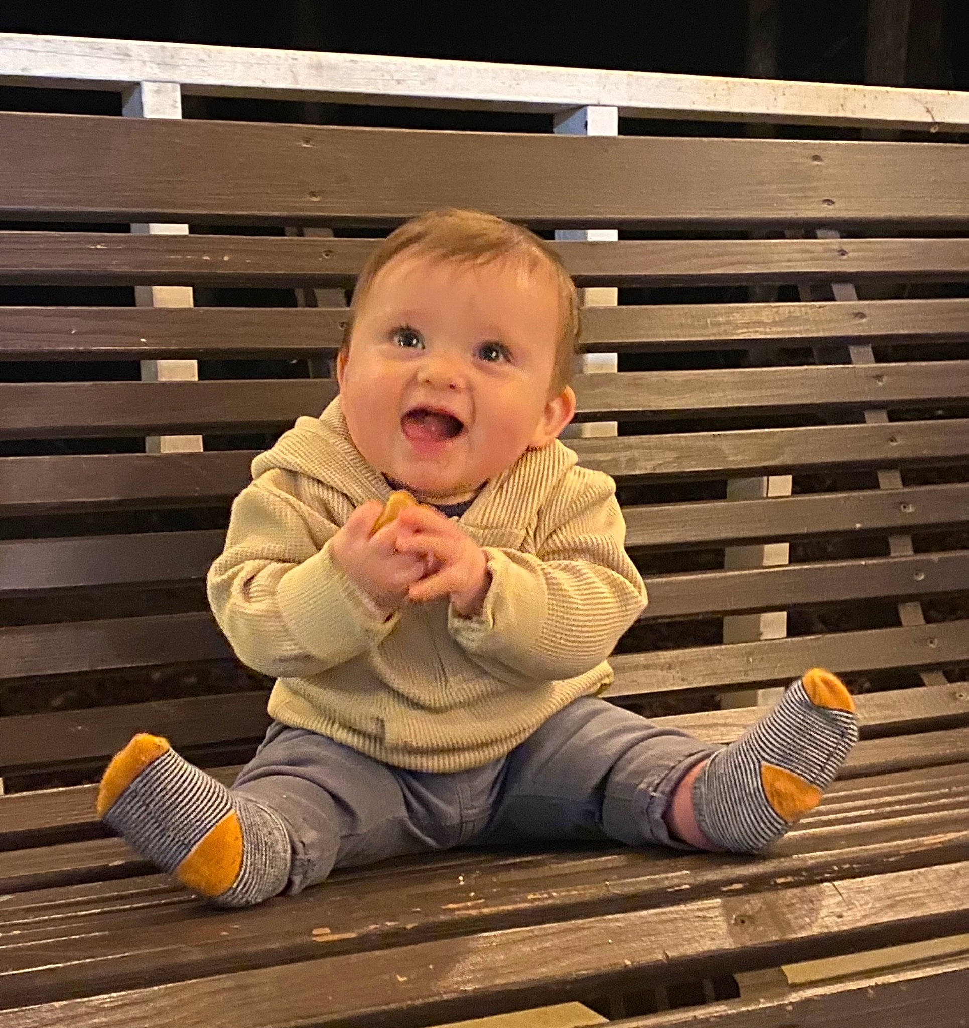 Clark is registered to the contest to win money with this photo: baby, baby_toddler_clothing, cheek, child, comfort, facial_expression, floor, flooring, fun, happy, hardwood, jacket, mammal, person, product, sleeve, smile, standing, tints_and_shades, toddler