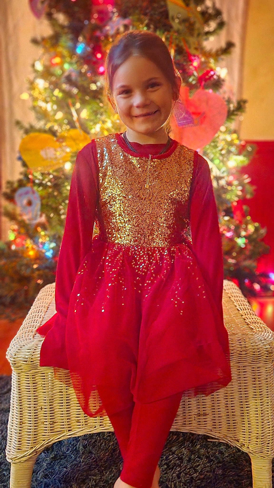 Timberlyn is registered to the contest to win money with this photo: christmas_decoration, christmas_ornament, christmas_tree, clothing, decoration, dress, embellishment, event, fashion_design, formal_wear, happy, holiday_ornament, joy, magenta, ornament, person, sleeve, smile, temple, toddler