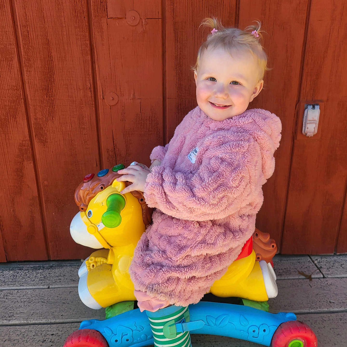 Byndi is registered to the contest to win money with this photo: baby, bodypart, clothing, coat, face, finger, footwear, hand, head, knitwear, machine, pants, person, photography, portrait, shoe, sitting, sweater, wheel, wood