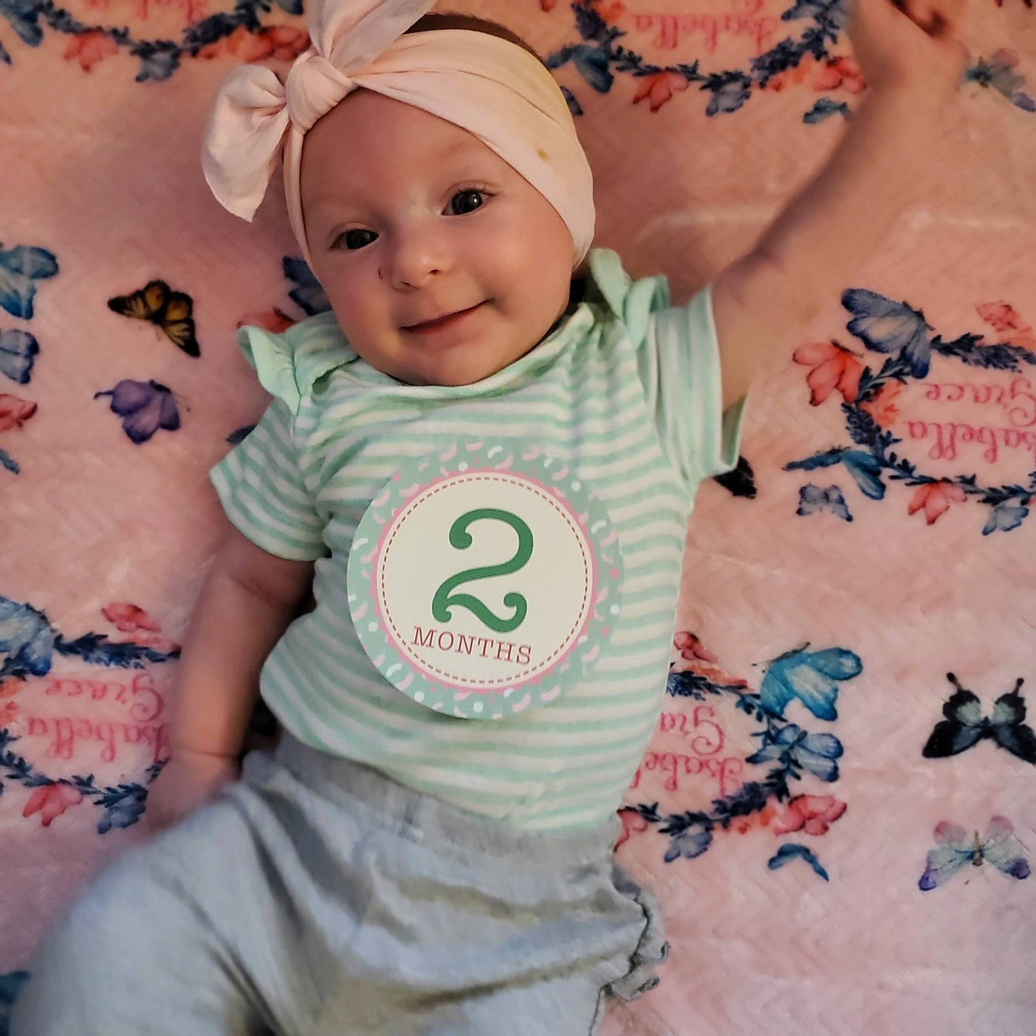 Isabella is registered to the contest to win money with this photo: arm, baby, baby_toddler_clothing, cap, cheek, cool, face, facial_expression, happy, head, headwear, joy, person, photograph, pink, product, skin, sleeve, smile, t_shirt
