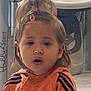 toddler, child, indoor, orange_jacket, hair_clip, surprised, face, person, young_child, expression, cute, cartoon_background, toy, floor, hair, clothing, closeup, portrait, young_person, casual