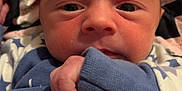 Brodie-Lee is registered to the contest to win money with this photo: baby, newborn, infant, face, hand, blanket, clothing, blue, skin, expression, portrait, cute, young, sleepwear, wrapping, soft, closeup, indoors, head, eyes