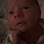 Brodie-Lee joined the competition — help win amazing prizes! baby, infant, closeup, face, hand, curious, wide_eyes, newborn, skin, portrait, person, indoors, cozy, dim_light, expression, cute, sleepwear, tattoo, adult_hand, resting