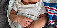 Matteo is registered to the contest to win money with this photo: baby, newborn, sleeping, blanket, infant, white_clothing, hands, face, peaceful, soft_texture, closeup, child, resting, cozy, cute, skin, portrait, indoors, wrapped, toddler