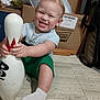 Elijah joined the competition — help win amazing prizes! toddler, child, smiling, bowling_pin, floor, sitting, cardboard_box, indoor, clothing, sock, toy, happy, person, cute, playful, young_child, hair, face, holding, home