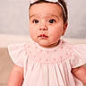 adorable, baby, child, closeup, curious_eyes, cute, face, girl, headband, indoor, infant, innocent_expression, pink_dress, portrait, ruffled_sleeves, sitting, skin, soft_lighting, white_bow, young_child