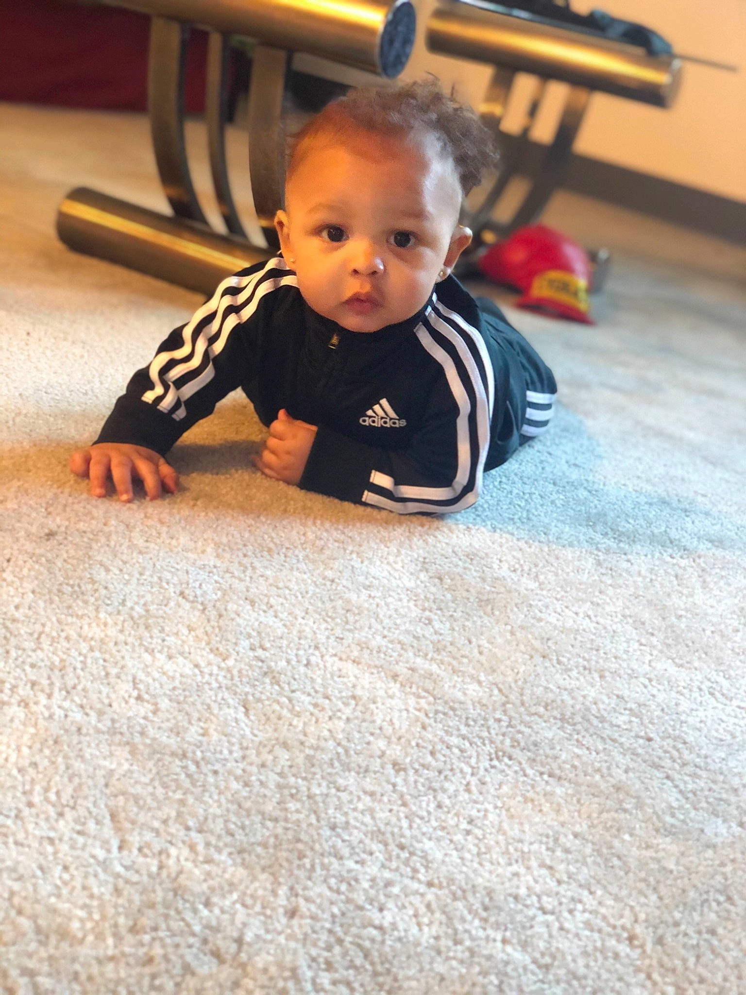 Jakai is registered to the contest to win money with this photo: baby, carpet, cheek, child, crawling, face, floor, flooring, fun, head, person, play, room, sitting, skin, smile, t_shirt, toddler, tummy_time, wood