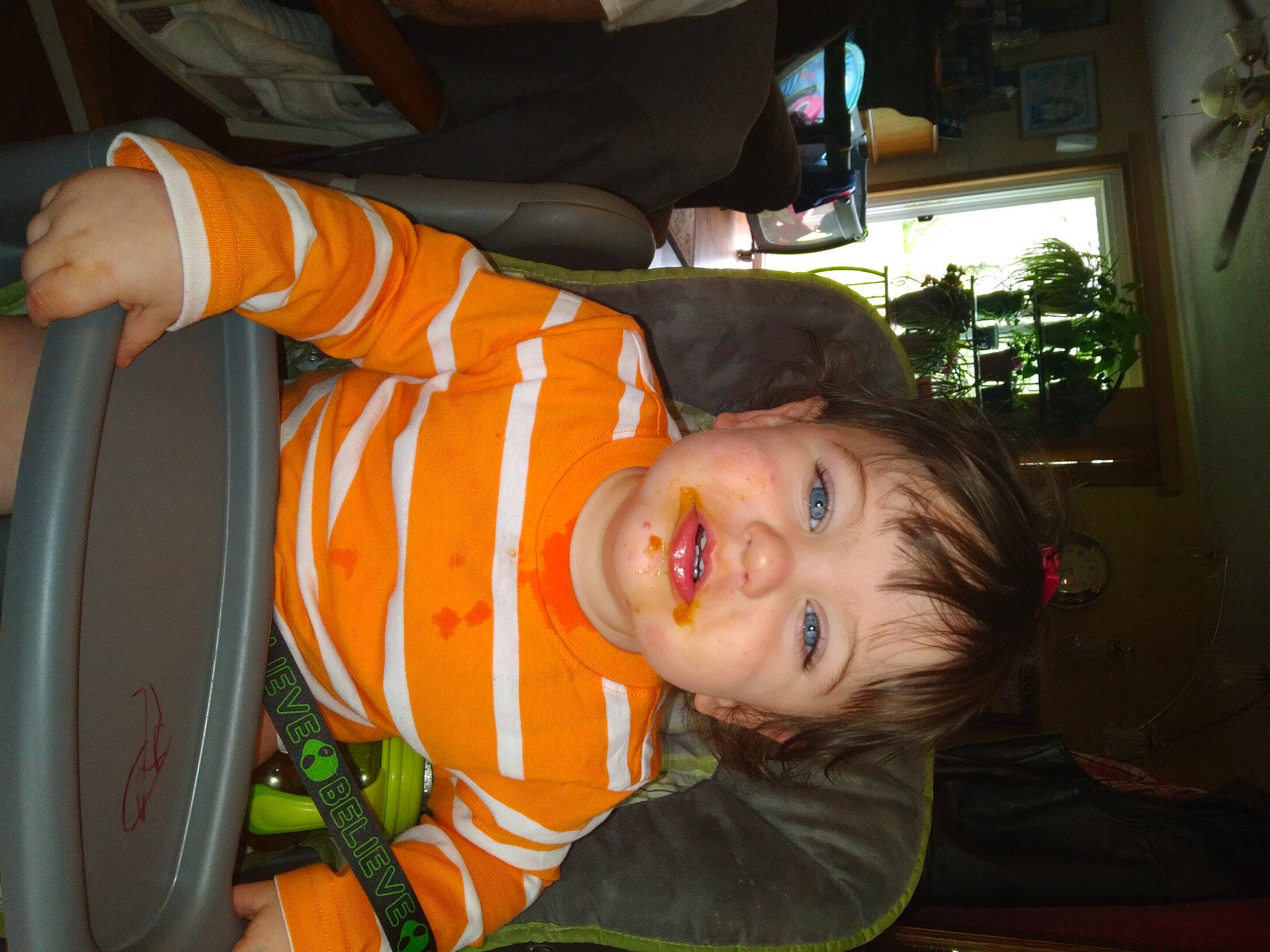 Elijah is registered to the contest to win money with this photo: child, family_car, fun, houseplant, luxury_vehicle, orange, person, plant, room, smile, toddler, vacation, vehicle, vehicle_door, window