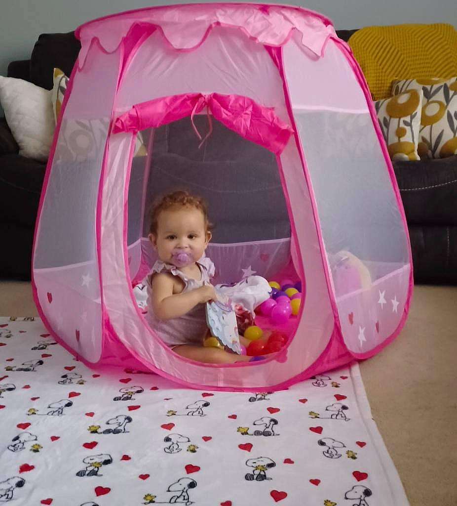 Nevaeh is registered to the contest to win money with this photo: baby, baby_products, carmine, chair, child, comfort, doll, event, fun, hair, head, linens, magenta, person, pink, product, room, sitting, tent, toddler