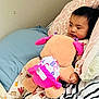 Raya joined the competition — help win amazing prizes! bed, blanket, child, comfort, cute, fabric, face, hand, indoors, pajamas, pattern, person, pillow, plush_toy, relaxing, resting, sleepwear, soft_toy, toy, young_child