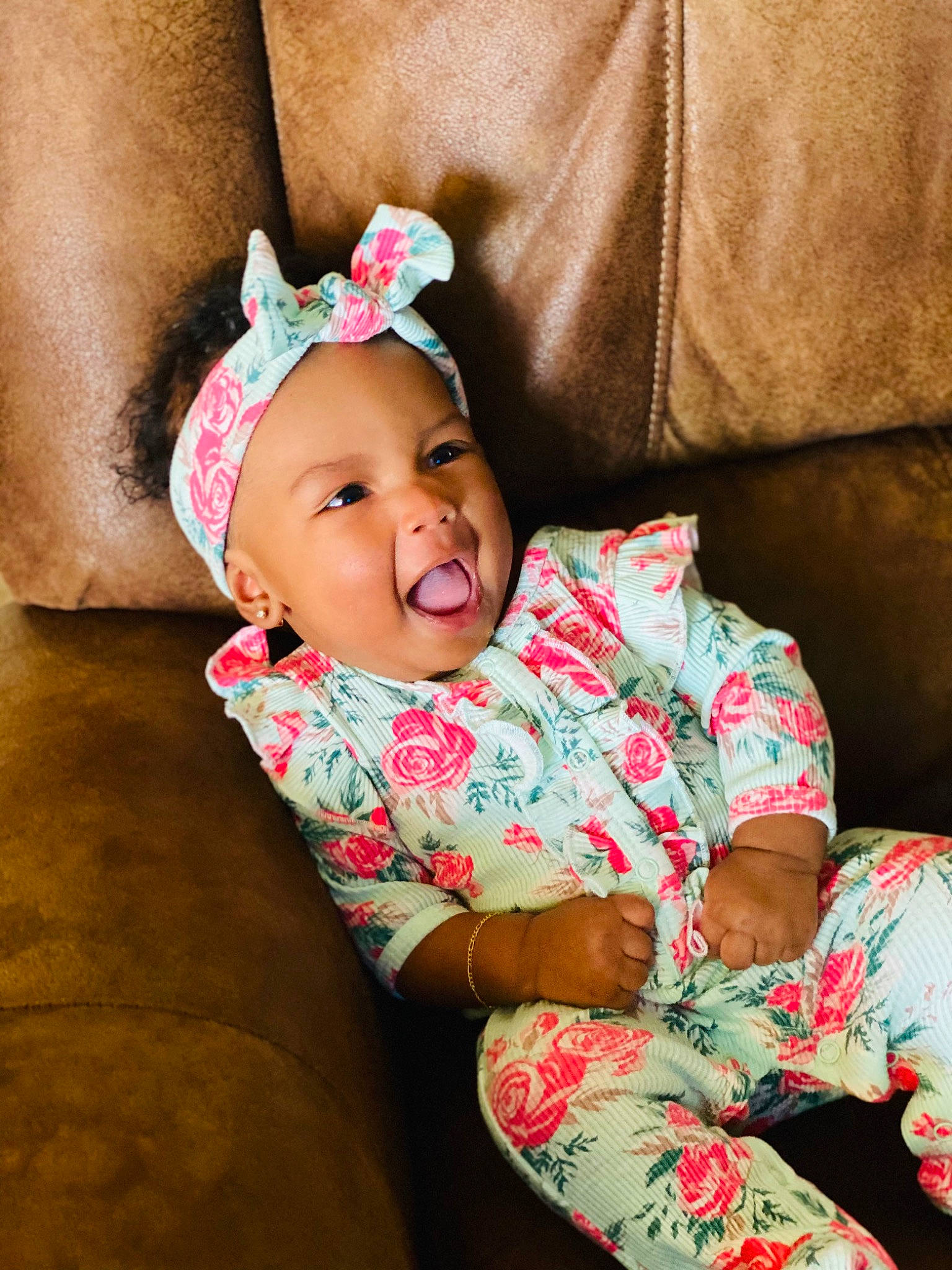 Nomi is registered to the contest to win money with this photo: baby, baby_toddler_clothing, cheek, child, comfort, dress, eye, happy, head, headwear, linens, lip, magenta, neck, pattern, person, pink, sitting, skin, sleeve