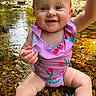 baby, child, creek, cute, eyes, face, greenery, hand, happy, legs, nature, outdoor, rocks, sitting, skin, smile, summer, sunlight, swimsuit, water