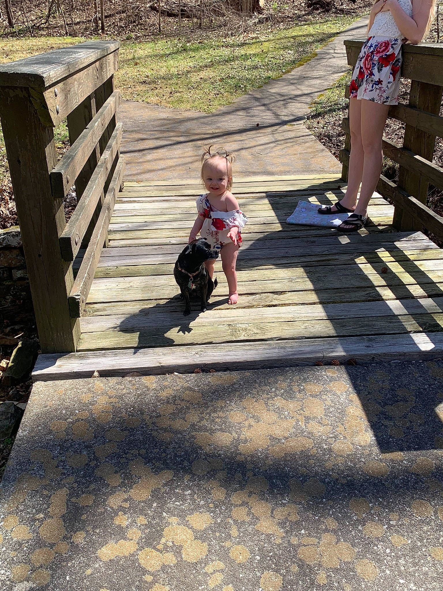 Dakota is registered to the contest to win money with this photo: asphalt, child, city, flooring, fun, grass, human_leg, joy, leg, leisure, person, recreation, road, road_surface, shadow, sidewalk, sitting, tints_and_shades, toddler, tree