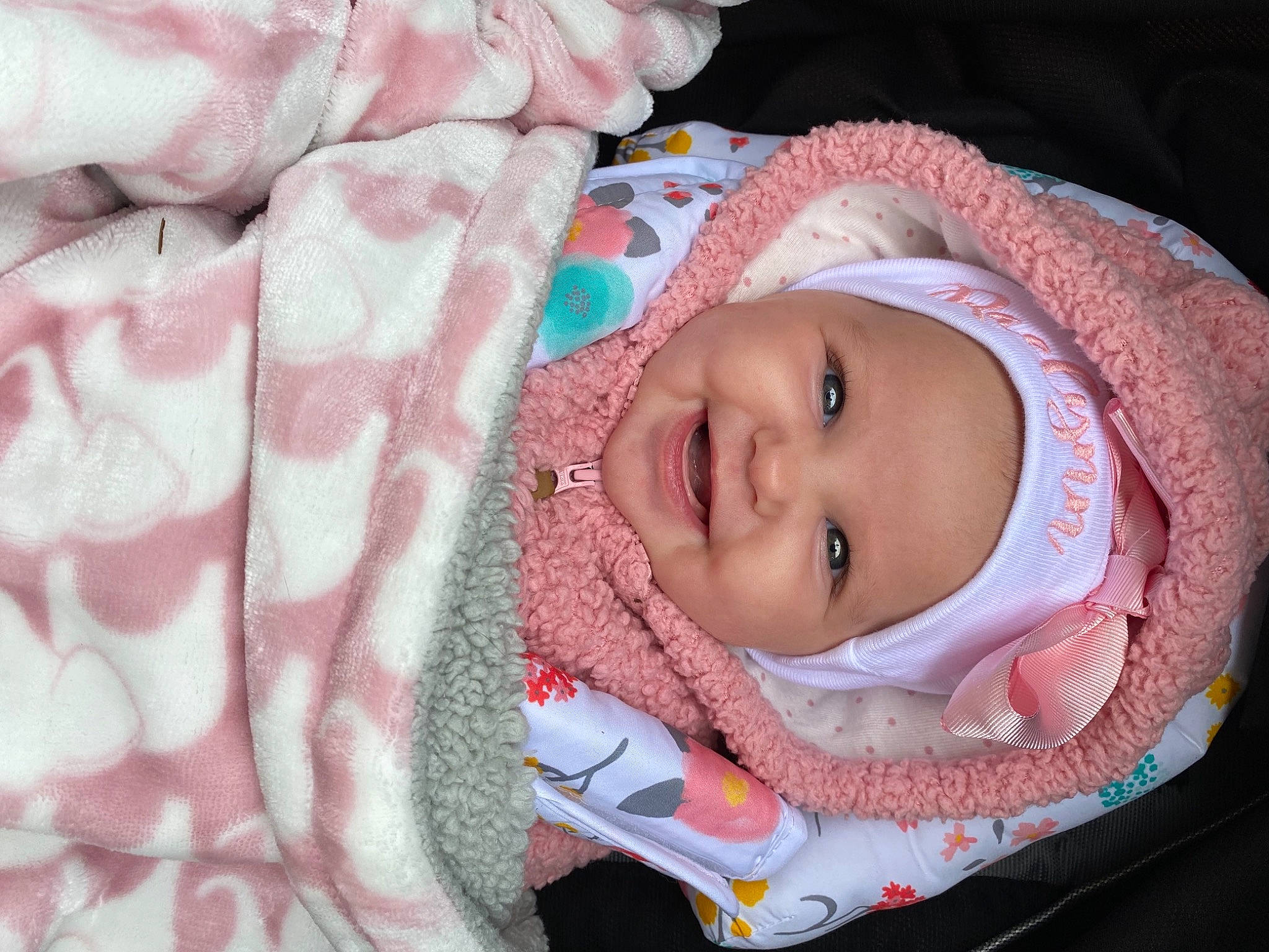 Raelynn is registered to the contest to win money with this photo: baby, baby_products, baby_toddler_clothing, cheek, child, close_up, comfort, face, facial_expression, happy, headwear, joy, linens, lip, nose, outerwear, person, pink, product, skin