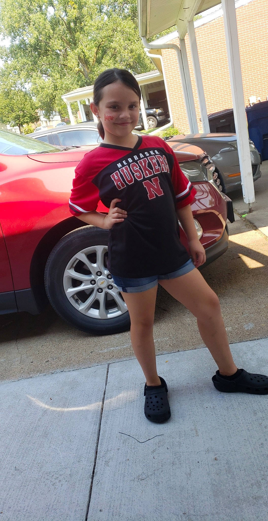 Briana joined the competition — help win amazing prizes! alloy_wheel, automotive_design, automotive_exterior, automotive_lighting, automotive_tire, bumper, car, hood, joy, land_vehicle, leg, motor_vehicle, person, red, shoe, shorts, street_fashion, thigh, tire, vehicle