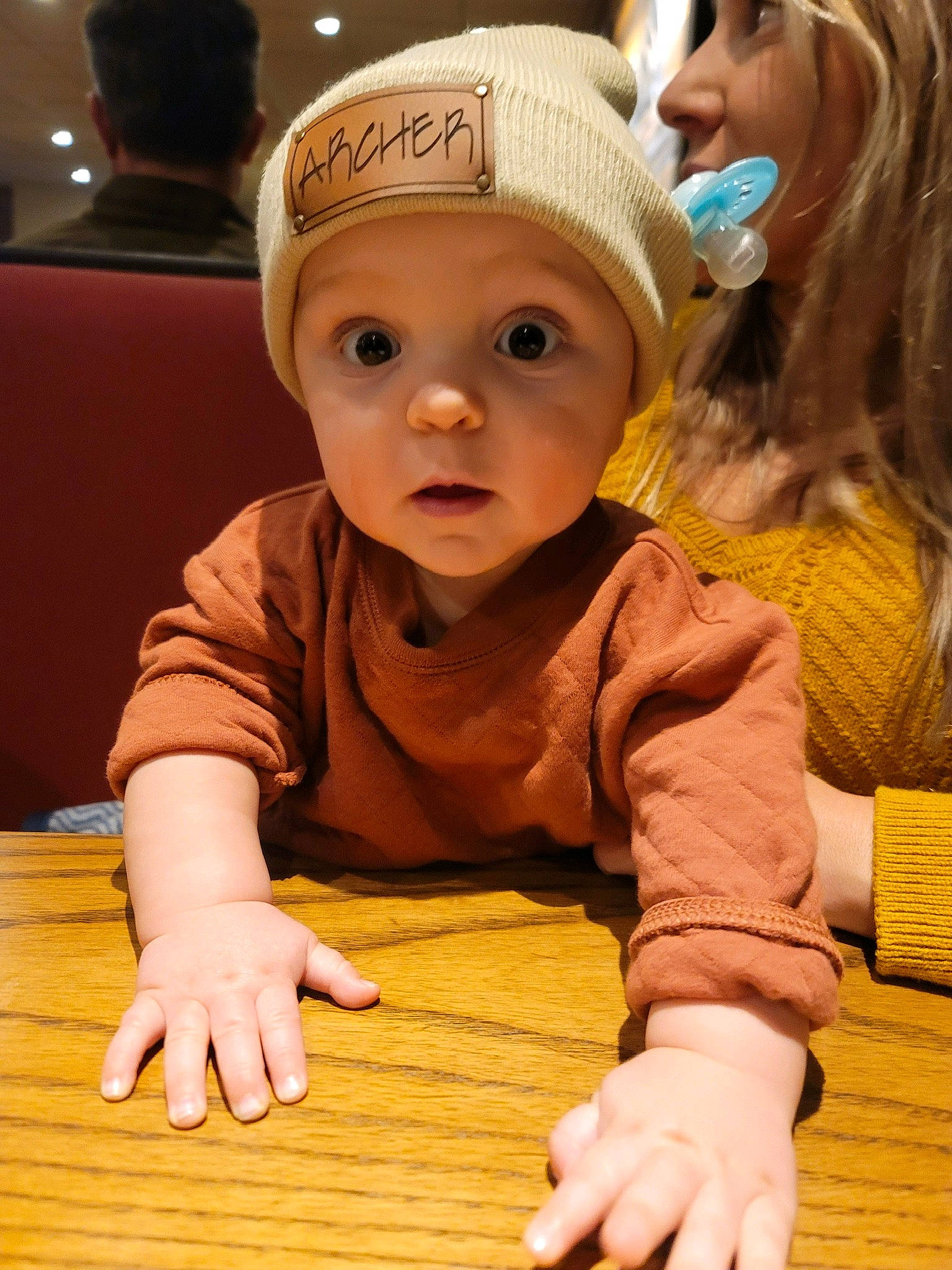 Archer joined the competition — help win amazing prizes! baby, baby_toddler_clothing, cap, cheek, child, event, facial_expression, finger, flooring, fun, happy, hardwood, head, headwear, people, person, skin, table, toddler, under_exposed