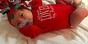 Katie is registered to the contest to win money with this photo: child, christmas, finger, girl, hand, holiday, infant, lap, product, red, skin, toddler