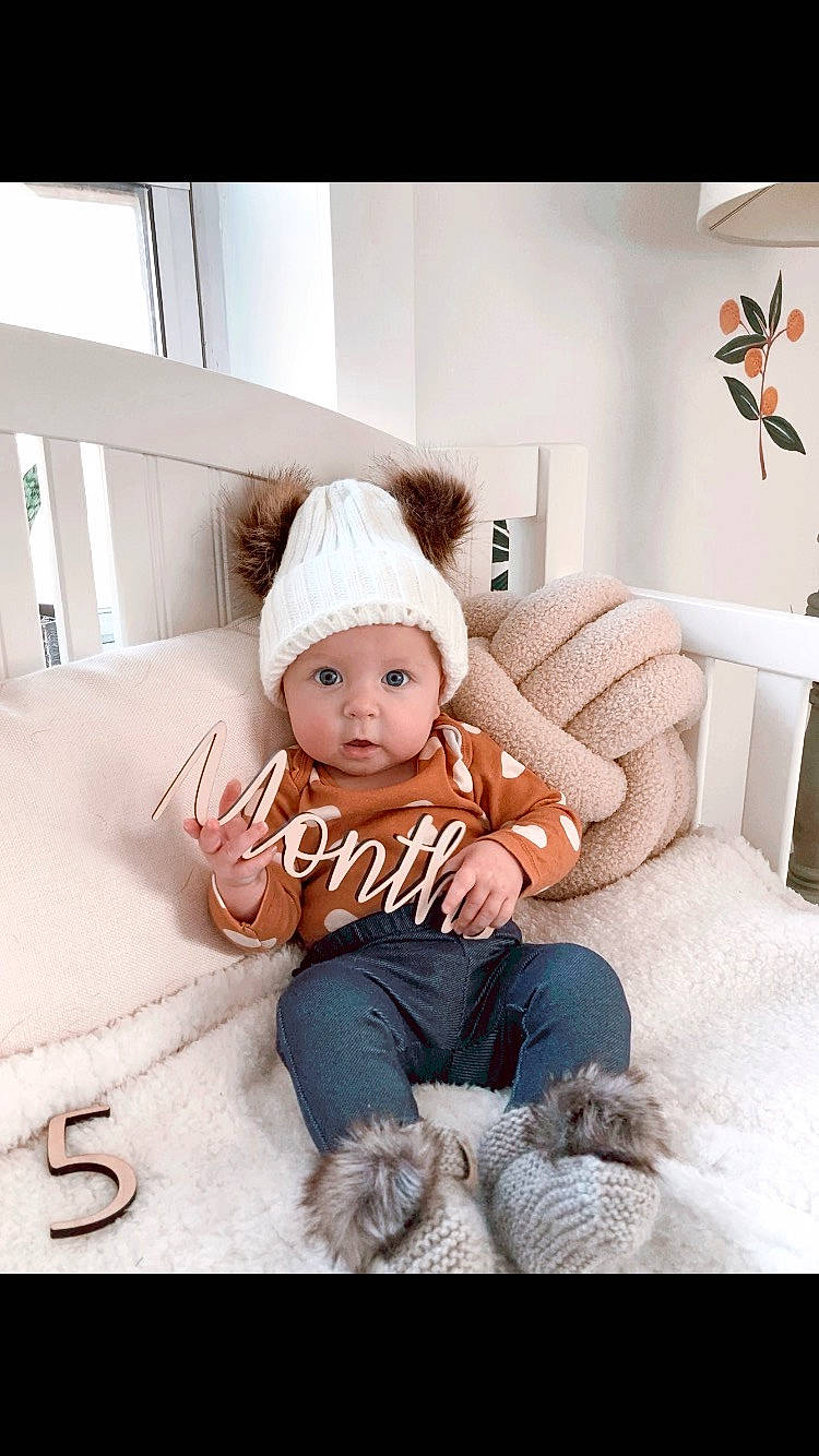 Harlow is registered to the contest to win money with this photo: baby, baby_toddler_clothing, child, comfort, couch, flash_photography, flooring, fur, happy, headwear, linens, pattern, person, picture_frame, portrait_photography, room, sitting, sleeve, t_shirt, throw_pillow