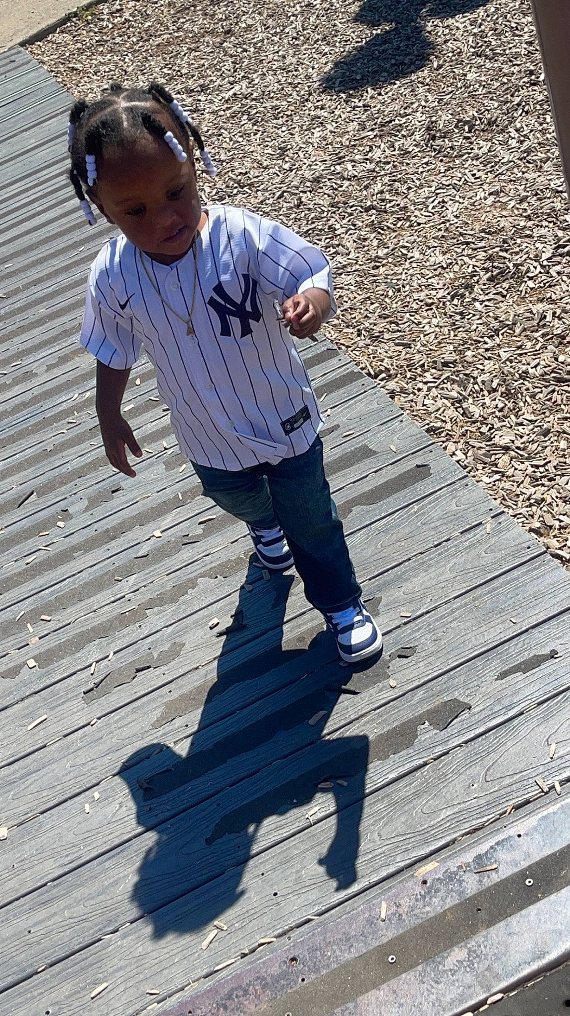 Asriel is registered to the contest to win money with this photo: child, cobblestone, denim, flooring, happy, human, human_leg, leg, leisure, pattern, people_in_nature, person, road_surface, roof, shadow, sidewalk, sitting, standing, toddler, walkway