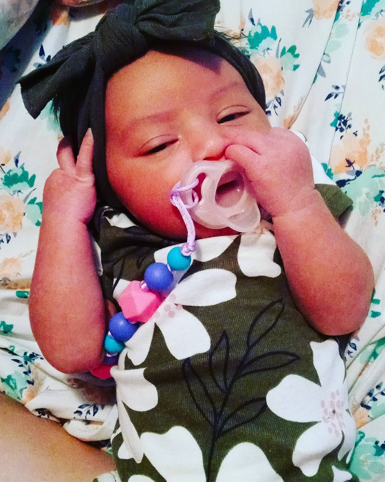 Ava is registered to the contest to win money with this photo: arm, baby, baby_toddler_clothing, cheek, eyelash, facial_expression, finger, gesture, hand, happy, head, headwear, lip, mouth, neck, nose, organ, outerwear, person, skin