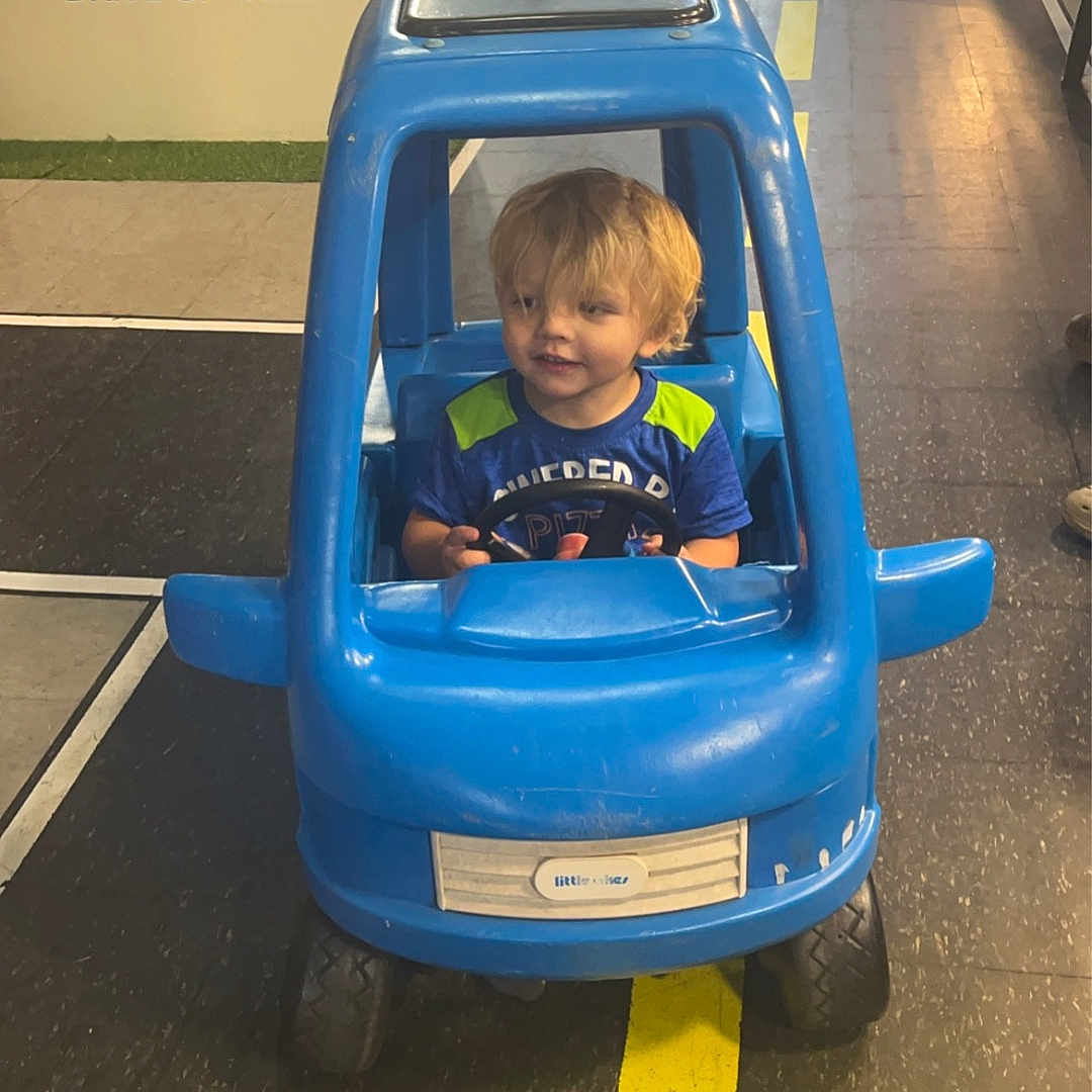 Kai joined the competition — help win amazing prizes! architecture, baby, building, car, city, clothing, face, head, machine, outdoors, person, photography, playarea, portrait, road, shelter, street, t_shirt, urban, wheel