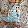 Lyanna a rejoint le concours — aidez-le/la à gagner de superbes lots ! baby, infant, denim_dress, headband, minnie_mouse, patterned_sheet, bird_prints, pillow, cartoon_lion, socks, lying_down, cute, child, soft_lighting, curious, indoors, clothing, fabric, portrait, close_up