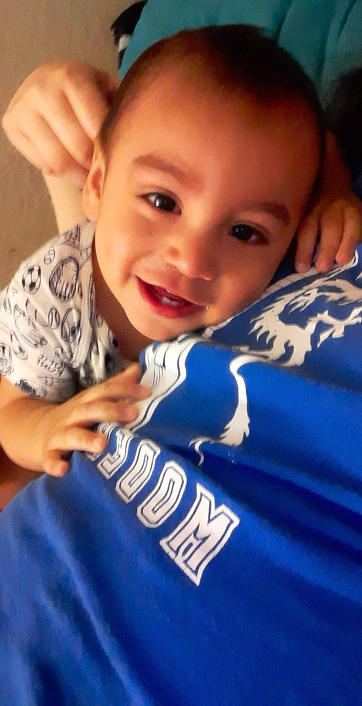 Gilberto is registered to the contest to win money with this photo: baby_toddler_clothing, cheek, child, comfort, cool, ear, electric_blue, eye, eyebrow, eyelash, face, facial_expression, finger, forehead, head, joy, lip, nose, person, skin