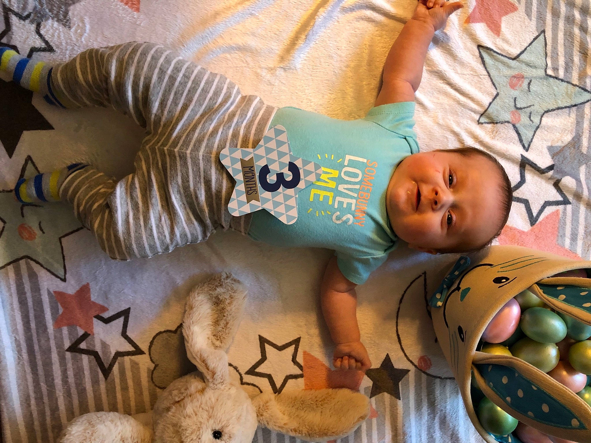 Maverick is registered to the contest to win money with this photo: arm, art, baby, baby_products, baby_toddler_clothing, child, comfort, design, happy, head, linens, mammal, pattern, person, room, snapshot, textile, toddler, vertebrate, white