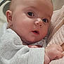 baby, infant, face, eyes, skin, clothing, hand, cuteness, portrait, closeup, young_child, newborn, cozy, soft_texture, expression, curious, indoors, human, person, child