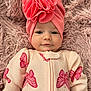 baby, infant, pink_turban, butterfly_pattern, onesie, blanket, fluffy_texture, cute, smiling, portrait, child, cozy, soft, headwear, lying_down, closeup, skin, eyes, happy, fashion