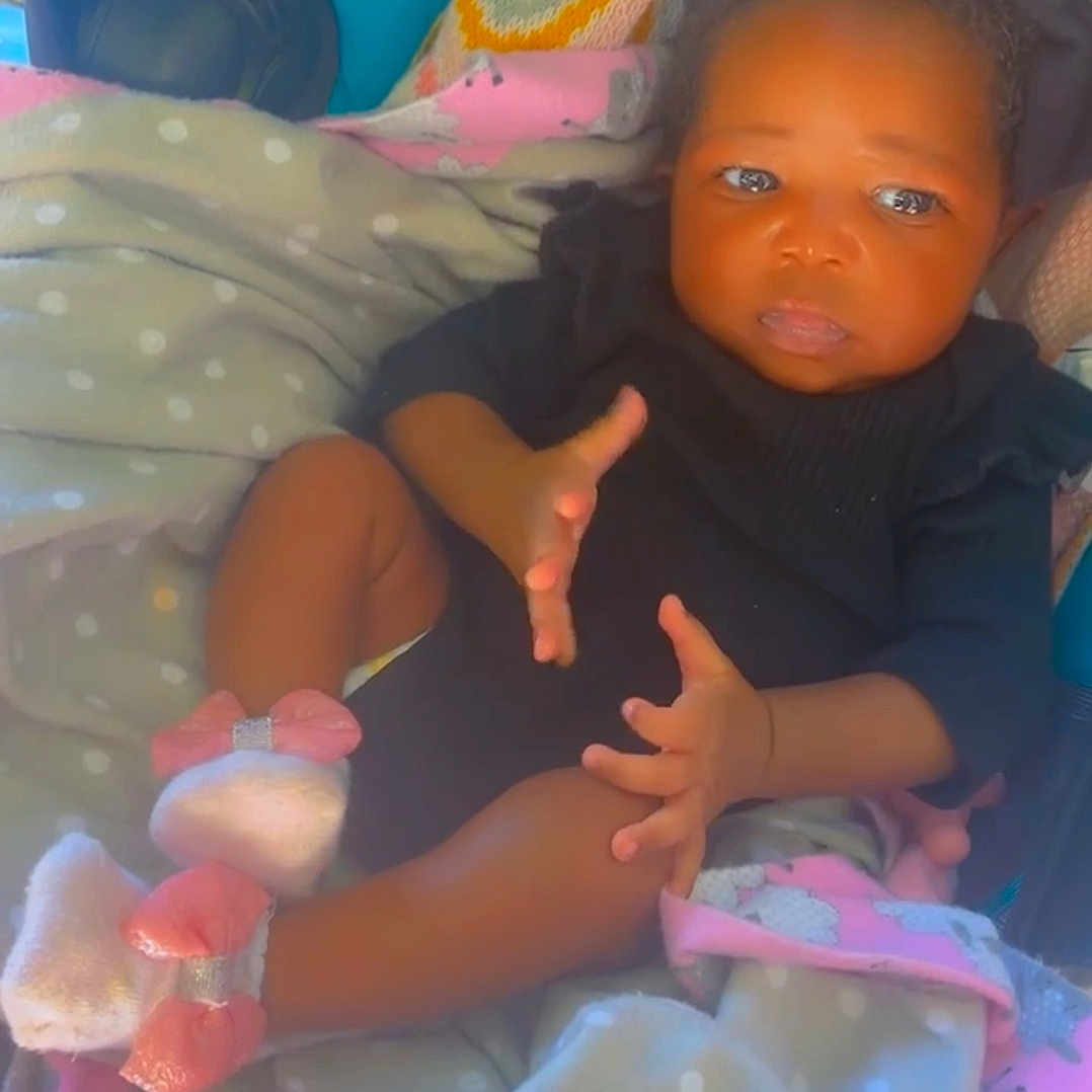 Ja'Nya is registered to the contest to win money with this photo: baby, black_clothing, blanket, booties, bow, child, cozy, cute, feet, hands, headband, indoors, infant, lying_down, pink, polka_dot, portrait, soft_texture, white, young_child