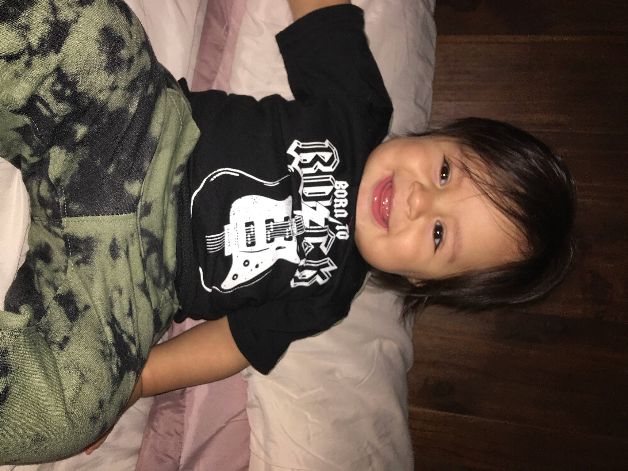 Jared is registered to the contest to win money with this photo: baby_toddler_clothing, black_hair, darkness, elbow, eye, face, flash_photography, fun, gesture, happy, head, joy, monochrome, monochrome_photography, pattern, person, sitting, sleeve, smile, t_shirt