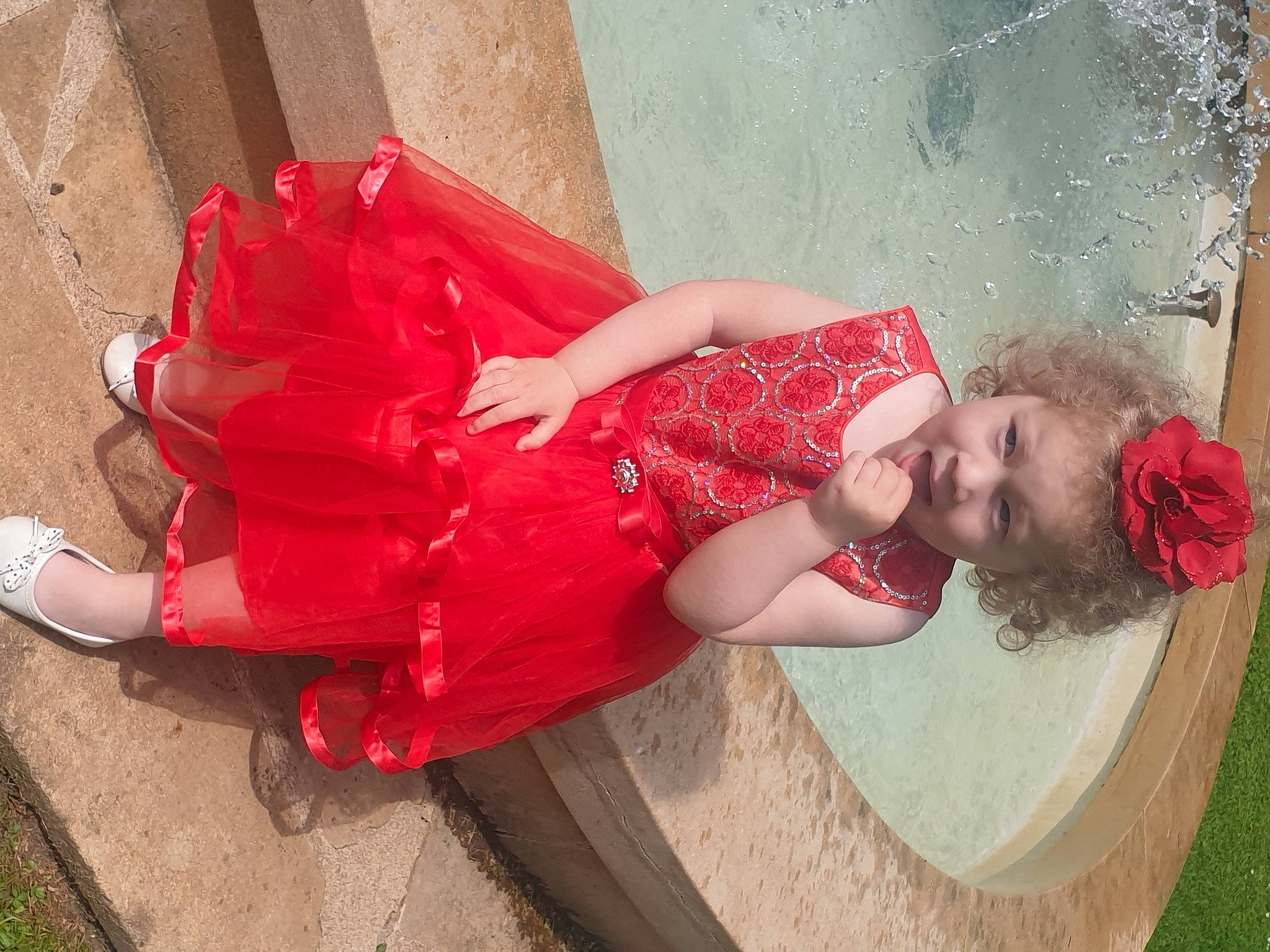 Eleonor participe au concours pour gagner de l'argent avec cette photo : carmine, child, dress, fashion_accessory, fun, happy, human_leg, long_hair, magenta, pattern, person, pink, sandal, shoe, sitting, skin, smile, thigh, toddler, trunk