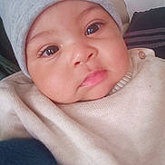 Ethan Maëron participe au concours pour gagner de l'argent avec cette photo : baby, infant, child, face, eyes, beanie, hat, cheeks, lips, sweater, button, close_up, portrait, adorable, indoor, pillow, blanket, gaze, rosy_cheeks, newborn