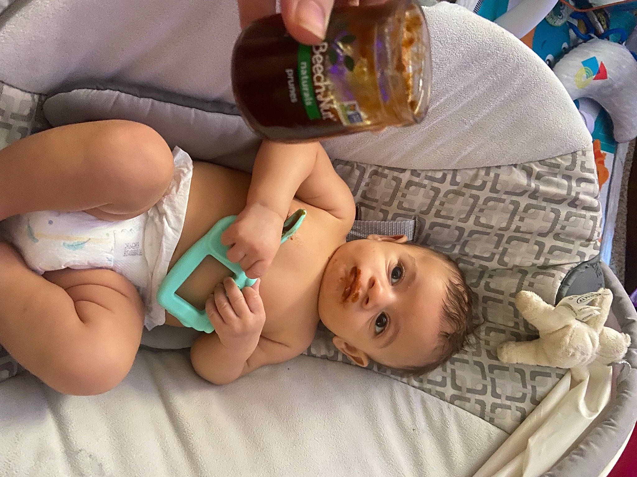 Desmond is registered to the contest to win money with this photo: abdomen, chest, child, comfort, facial_expression, finger, hairstyle, hand, headgear, human_body, joint, knee, leg, mammal, mouth, person, skin, textile, thigh, toddler