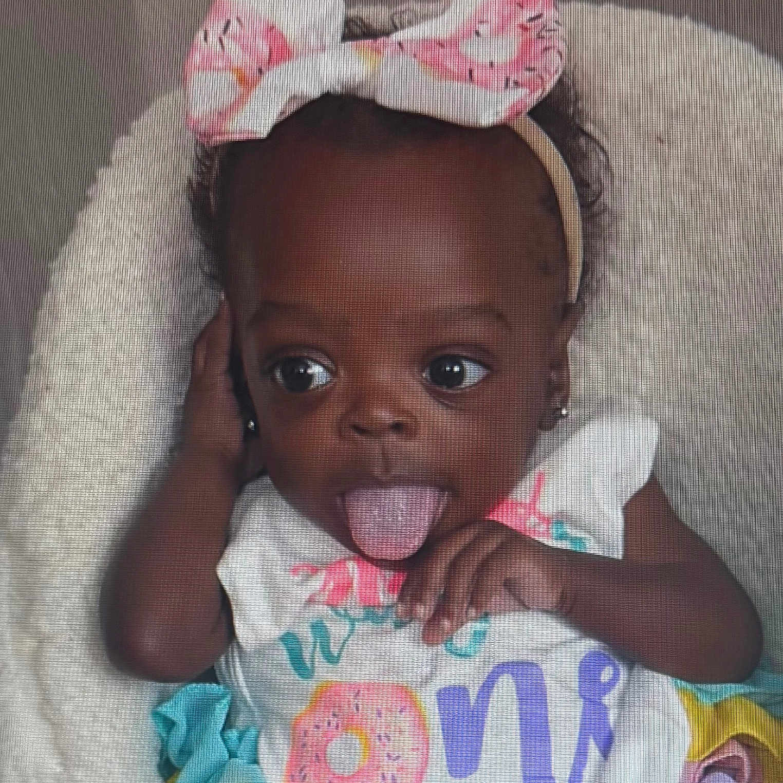 Taisley joined the competition — help win amazing prizes! baby, bow, child, colorful_clothing, cute, donut, first_birthday, fluffy, happy, headband, indoors, infant, person, pink, playful, portrait, smiling, soft_texture, tongue_out, young_child