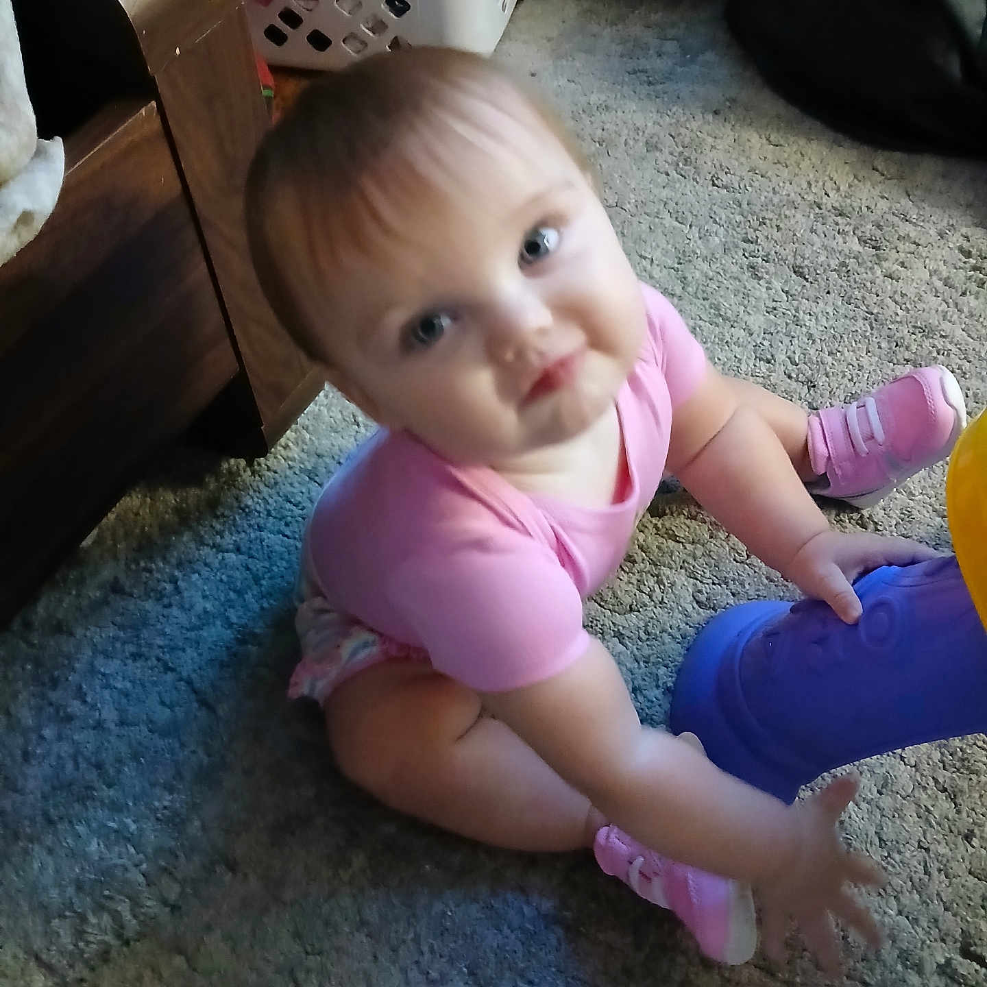 Lemailey joined the competition — help win amazing prizes! baby, child, infant, sitting, carpet, indoor, portrait, face, blue_eyes, blond_hair, pink_shirt, pink_shoes, purple_toy, toy, laundry_basket, furniture, home, candid, pouting, smiling